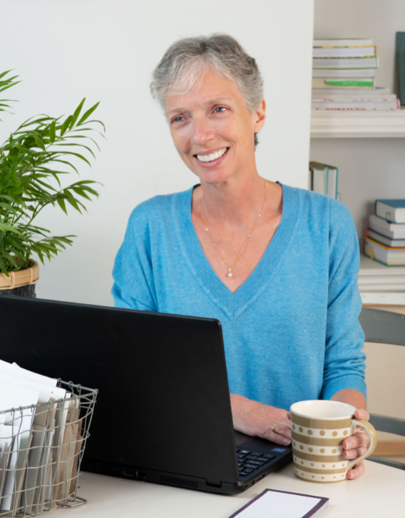 Elizabeth Barnes sits in front of computer