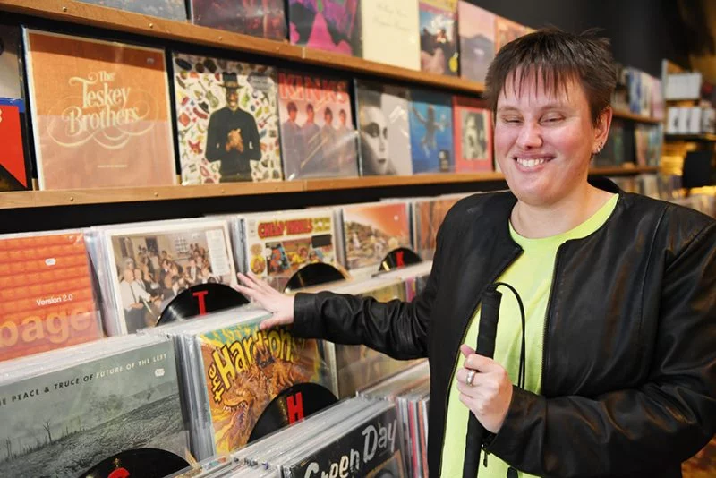 A woman flicks through record albums.