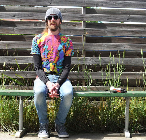 James Newton sitting on a bench with his white cane